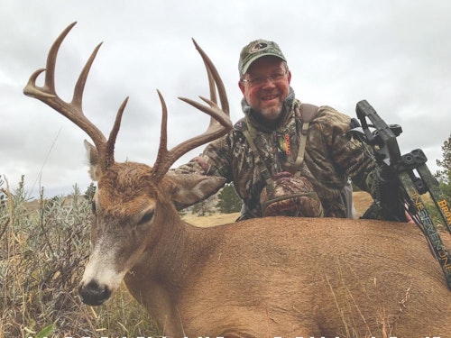 After spending days in bed with an abdominal infection, the author is all smiles with the mature whitetail that showed up on evening four of the hunt. 