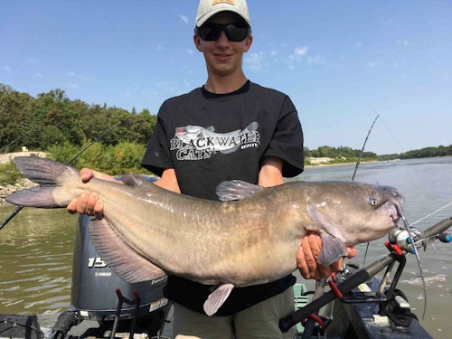 Elliott with his 27-pounder, the heaviest cat landed on the family's 2-day fishing adventure.