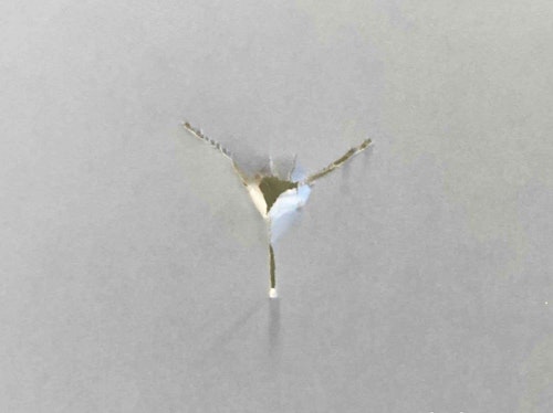 After setting the arrow rest and nocking point on the EnVision, the author’s first shot through paper produced this perfect bullet hole.