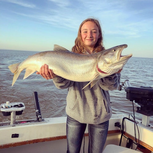 A FishNorthMN client holds a monster 34-inch lake trout caught during June 2019.