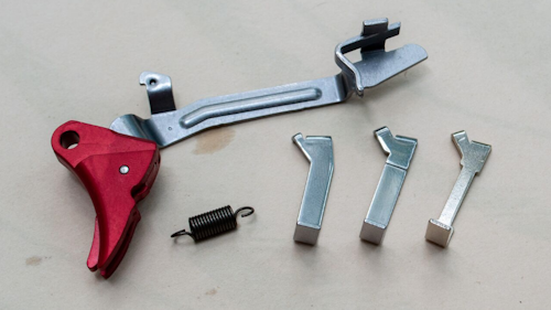 These three different trigger connectors offer three different choices of weight and trigger sensation. The six-pound trigger spring reduces the pull weight by assisting the press motion. Photo: Tom McHale