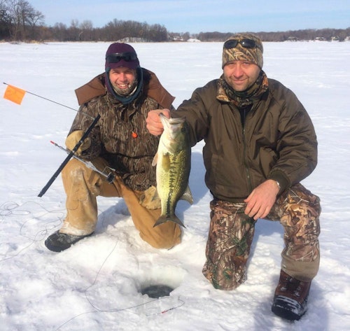 The author, left, and a friend show that bass can be caught on tip-ups, too. Unlike pike, however, bass rarely strike dead baits.