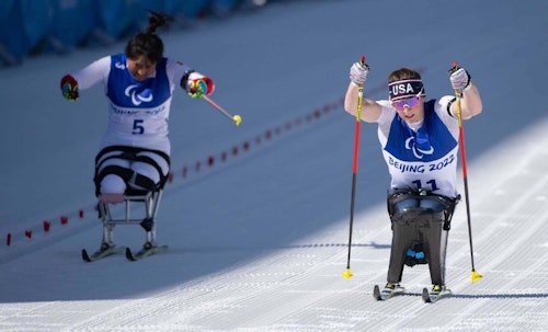 Team USA’s Kendall Gretsch (right) skis for gold during the recent 10k sit-ski Para biathlon event in Beijing.