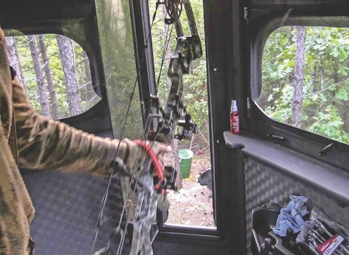 As the giant bear approached the bait site, the author notes that it dwarfed the nearby 55-gallon drums.