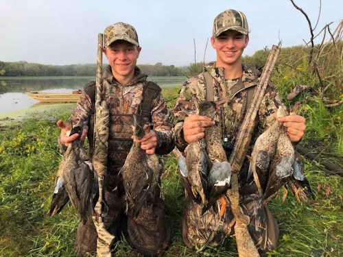 The author’s oldest son Elliott (right) and his friends regularly use a 12-foot jon boat (see it in the background?) to reach prime out-of-the-way duck hunting spots.
