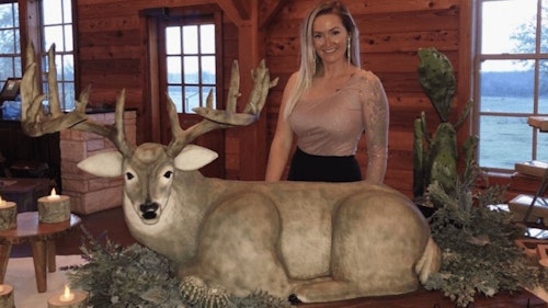 Cake creator Dusty Sinclair with her life-sized whitetail buck wedding cake.