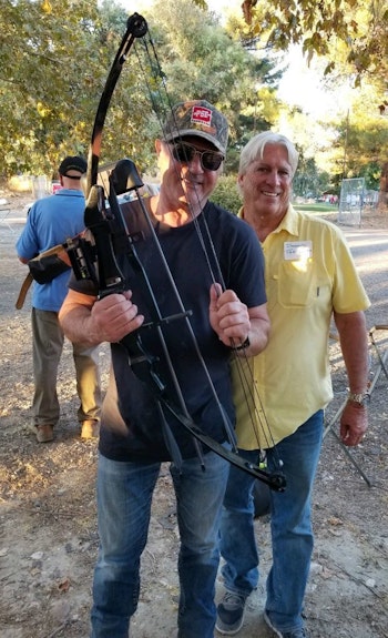 Frank Stallone holding the Rambo bow that Diamond Farnsworth (right) shot 37 years ago.