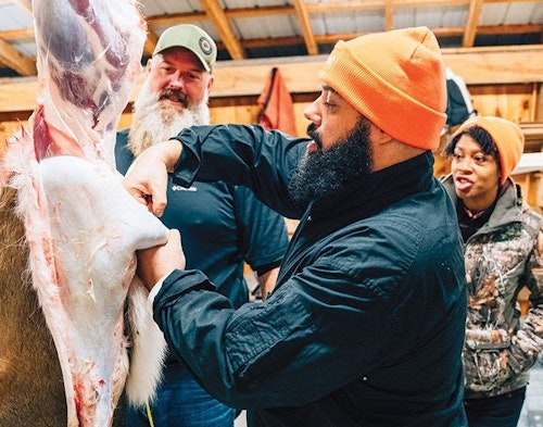 Brian Bird, a volunteer with Backcountry Hunters & Anglers who has helped with previous Field to Fork hunts in New York, leads a processing demonstration while new hunter Avery Toledo helps skin.