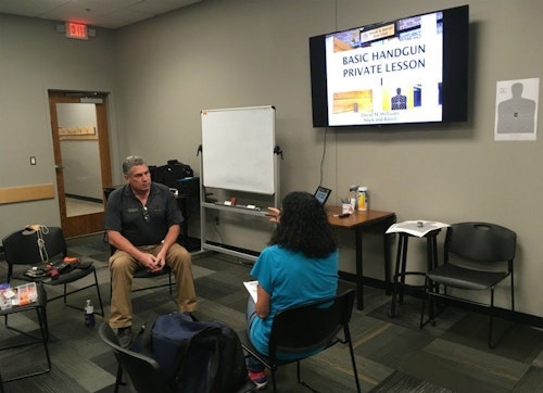 Instructor David Williams explains to Claire what he’ll cover during the 2-hour basic handgun lesson.