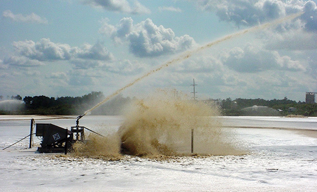 Lagoon aerator includes water cannon for foam suppression