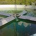 Aeration float folds for deployment through reservoir manway